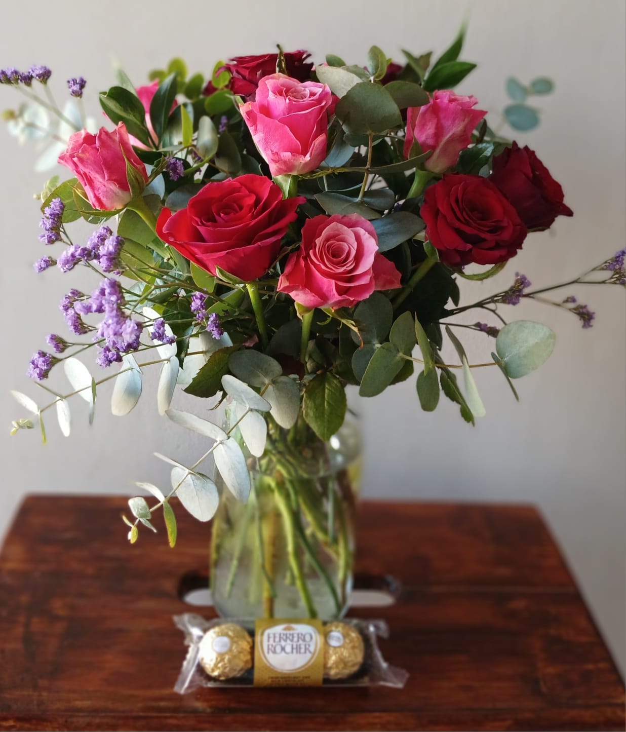 Pink and red roses in vase with Ferrero